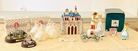 Group view of castles, cookie jar, bride figurines, coach, boxes and accessories