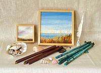 Overall lot view with paintings, shells, wind chimes, inkwell
