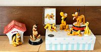 Group shot of all eight Pluto items on shelf for scale and completeness