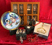 Group view of plate, boxed ornament, soldier ornaments, nutcracker cabinet, sleigh and hooks