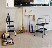 Group shot of vacuum, ladders, cleaning tools, box of accessories and switches
