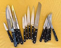 All 17 knives laid out on yellow background