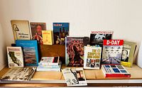 Full group of assorted books and pamphlets displayed on shelf