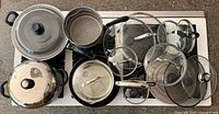 Full cookware set arranged on stovetop showing all pieces