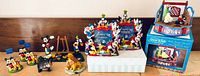 Group shot of entire lot displaying all figurines, frames, musical diorama and box