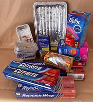 Group shot of all boxes of foil, wax paper, plastic wrap, Ziploc bags, foil pans and plastic containers
