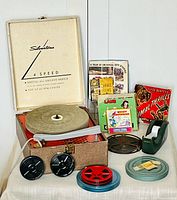 Group shot of turntable, film reels, tape dispenser and boxes