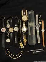 Group shot of all watches, bands and buckle on black background