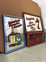 Group shot of both mirrored signs and pistol shadow box