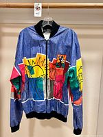 Front view of multicolor Tyvek Disney Marathon 96 jacket on hanger