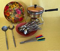 Entire lot: fondue pot on stand, forks, mixed flatware, salad servers, bowls