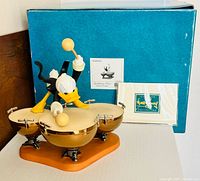 Front view of Donald Duck figurine with box, COA, and paperwork