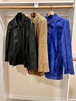 Front view of all three jackets hanging side-by-side