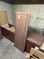 Tall wood cabinet carcass, partitions visible
