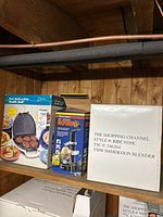 Boxed Deni Health Grill, Starfrit Rotato peeler, and 550 W immersion blender on shelf