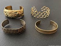 Group shot of four sterling silver cuff bracelets showing their different designs