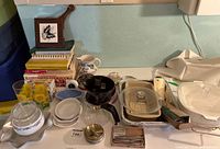 Overall view of mixed household and kitchen items laid out on counter