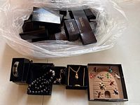 All five jewelry pieces displayed in open Joan Rivers boxes with additional closed boxes in background