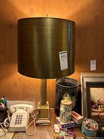Full view of lamp with shade showing gold-tone finish and overall design