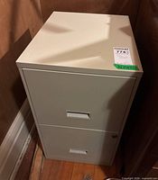 Full exterior view of beige two-drawer metal filing cabinet