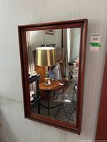 Front view of mirror showing wood frame and reflection