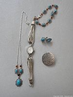 Full group showing brooch, watch, necklace, bracelet, earrings