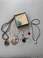 All six sterling silver necklaces and pendants displayed