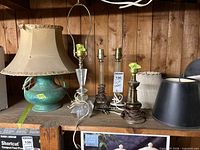 All five lamps and three shades on shelf