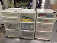 Front view of three Gracious Living rolling storage carts showing brand labels, drawers and wheels