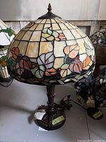 Full view of stained glass lamp showing shade, base, cord