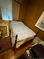 Full bed assembled with posts, mattress, surrounding items for scale