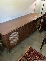 Full view of Zenith wood console stereo cabinet showing lattice speaker fronts and overall size