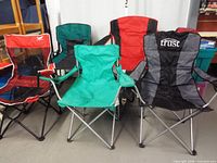 Group shot of five folding chairs showing colors and styles