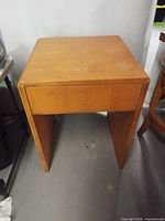 Front view of wooden end table showing overall structure and finish