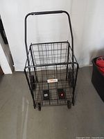 Full view of wire shopping cart, handle extended