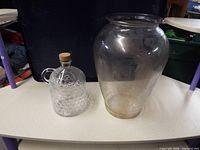 Vase and jug side by side on tabletop