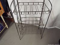 Full view of metal plant stand showing frame and shelves