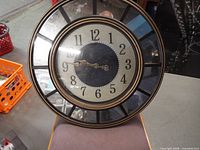 Front view of entire clock showing mirrored edge and dial