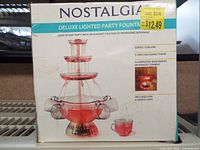 Front of box showing product name and image of fountain