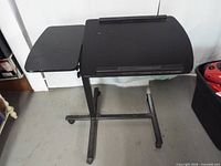 Overall view of rolling cart showing split tabletop and casters