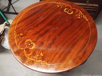 Tabletop showing floral inlay and finish wear
