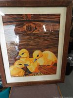Full view of framed artwork showing ducklings and frame
