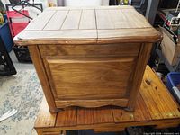 Front view of solid wood table showing plank top, rounded edges and sides