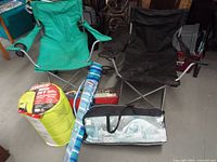 Overall lot showing two chairs, sleeping bag, umbrella sleeve, tent bags