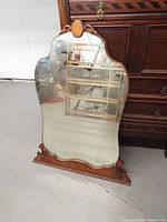 Full front view of mirror showing entire frame and glass
