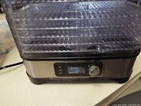 Front view showing stacked clear trays on stainless steel base of VIVOHOME dehydrator