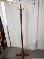 Full front view of the standing wood coat/hat rack showing entire height and base