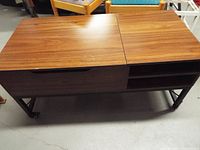 Top view of entire rectangular table showing woodgrain surface and metal base on casters