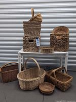 Group shot of all twelve baskets arranged on and around white table
