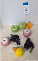 Group shot showing all eight ceramic fruit pieces